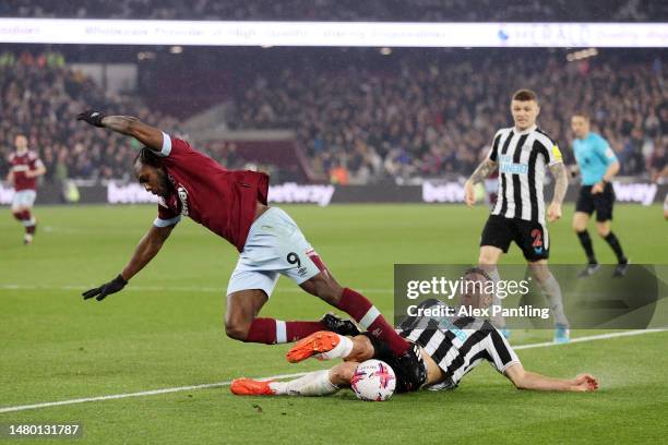 Michail Antonio of West Ham United is tackled by Fabian Schaer of Newcastle United during the Premier League match between West Ham United and...