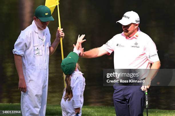 Shane Lowry of Ireland high fives his daughter Iris Lowry on the ninth green during the Par 3 contest prior to the 2023 Masters Tournament at Augusta...