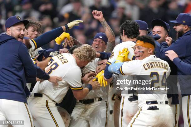 Garrett Mitchell of the Milwaukee Brewers celebrates with his teammates after hitting a walk-off solo home run against the New York Mets in the ninth...