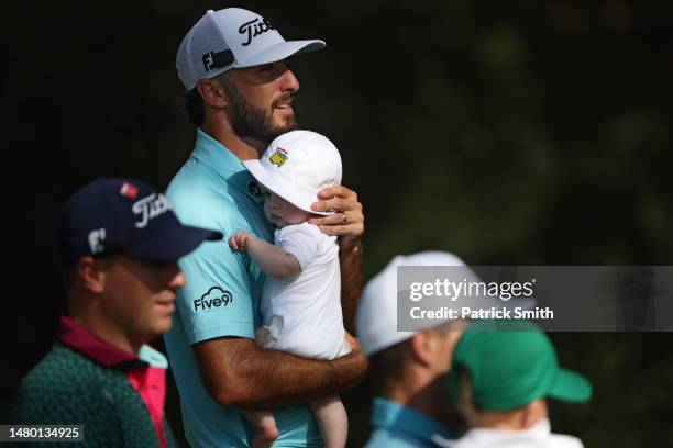 Max Homa of the United States walks with his son, Cam, during the Par 3 contest prior to the 2023 Masters Tournament at Augusta National Golf Club on...