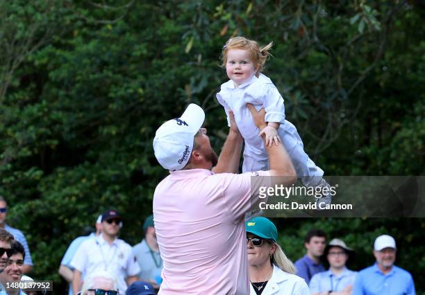 Shane Lowry of Ireland lifts his daughter Ivy during the par 3 competition prior to the 2023 Masters Tournament at Augusta National Golf Club on...
