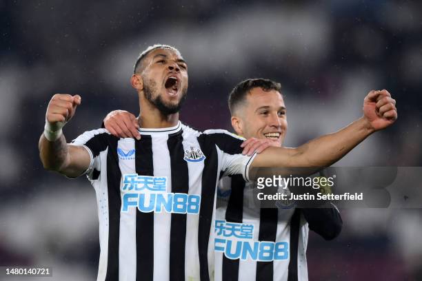 Joelinton of Newcastle United celebrates with Javi Manquillo after scoring the team's fifth goal during the Premier League match between West Ham...