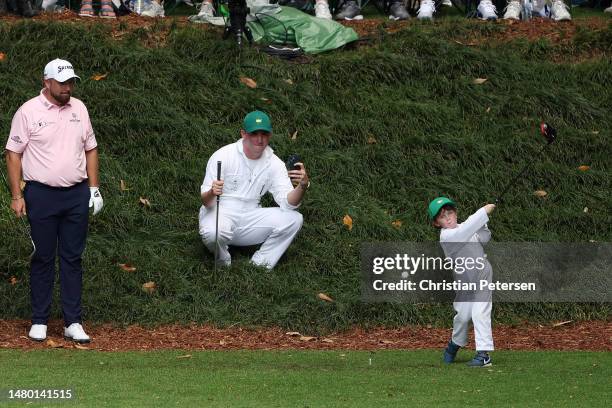 Tommy Fleetwood of England son Franklin plays a shot from the ninth tee during the Par 3 contest prior to the 2023 Masters Tournament at Augusta...