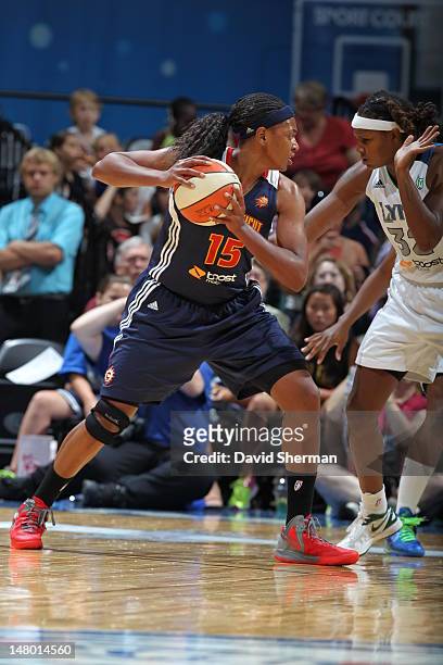 Asjha Jones of the Connecticut Sun looks to pass the ball against Rebekkah Brunson of the Minnesota Lynx in the game on July 7, 2012 at Target Center...