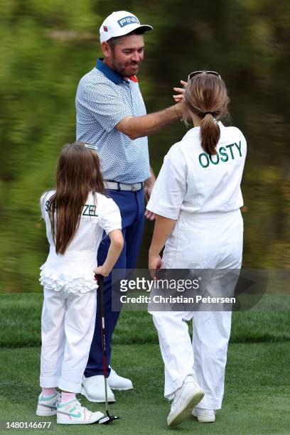 Louis Oosthuizen of South Africa high fives his wife, Nel-Mare Oosthuizen, on the ninth green during the Par 3 contest prior to the 2023 Masters...