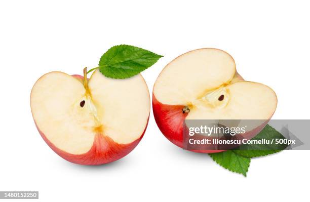 red apple cut in half with green leaf isolated on white background,craiova,romania - apple slice stock pictures, royalty-free photos & images