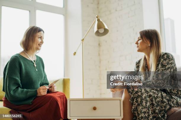 two women in armchairs are sitting and talking - prophet stock pictures, royalty-free photos & images