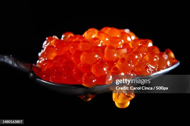 close-up of spoon in spoon against black background,romania - red caviar stock pictures, royalty-free photos & images