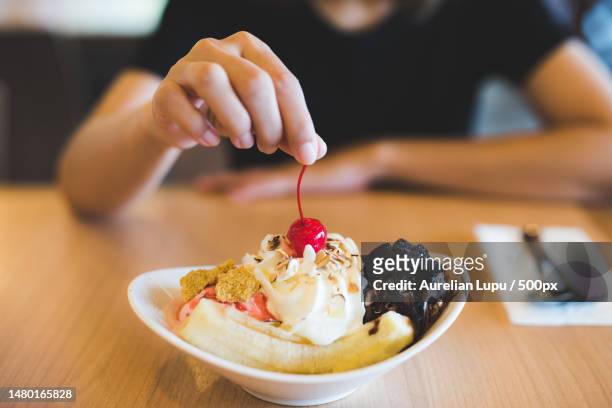 midsection of woman having dessert in plate on table,romania - sundae stock pictures, royalty-free photos & images