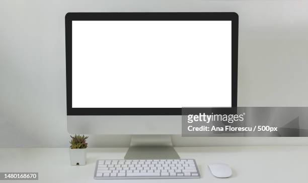 close-up of desktop pc on desk against white background,romania - computer mouse table stock-fotos und bilder