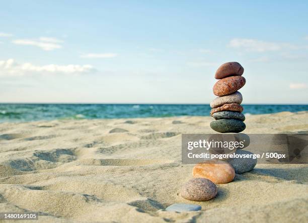 close-up of stacked stones at beach against sky,curonian spit,russia - pyramid rock beach fotografías e imágenes de stock