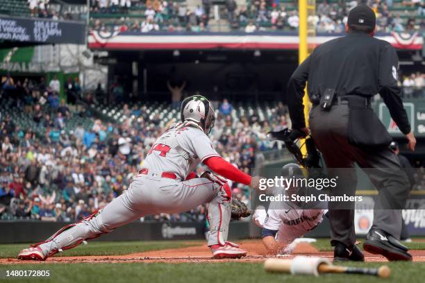 Logan O'Hoppe of the Los Angeles Angels tags out Ty France of the Seattle Mariners at home plate during the first inning at T-Mobile Park on April...