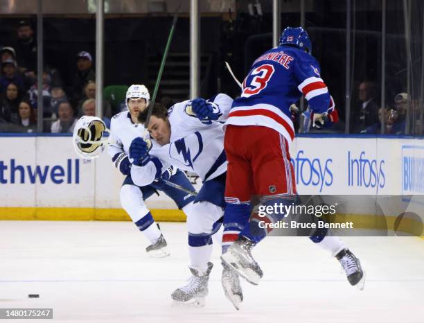 Ross Colton of the Tampa Bay Lightning is hit by Alexis Lafreniere of the New York Rangers during the first period at Madison Square Garden on April...