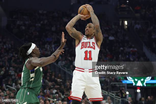 DeMar DeRozan of the Chicago Bulls shoots over Jrue Holiday of the Milwaukee Bucks during the first half of a game at Fiserv Forum on April 05, 2023...