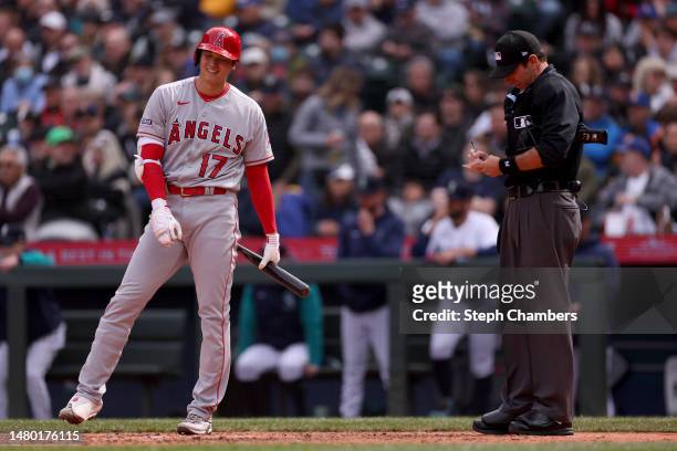 Umpire Pat Hoberg calls Shohei Ohtani of the Los Angeles Angels for a pitch clock violation during the sixth inning against the Seattle Mariners at...