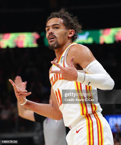 Trae Young of the Atlanta Hawks reacts after hitting a three-point basket against the Washington Wizards during the first quarter at State Farm Arena...