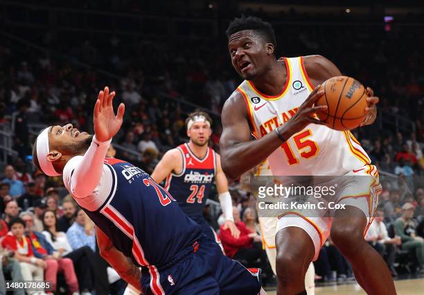 Clint Capela of the Atlanta Hawks draws a foul as he drives against Daniel Gafford of the Washington Wizards during the first quarter at State Farm...
