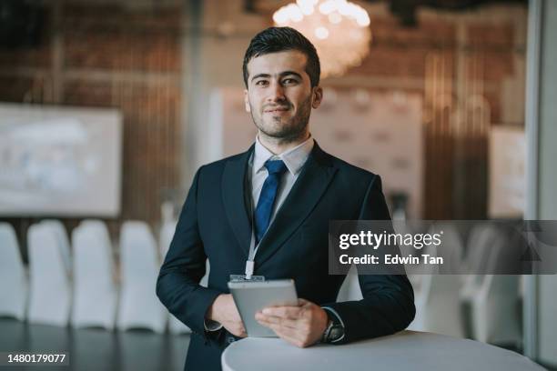 successful asian businessman looking at camera in seminar workshop business conference - central asia stock pictures, royalty-free photos & images