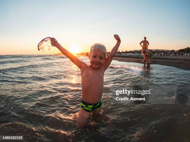 caucasian boy ready for snorkeling in the sea - jumping sun bildbanksfoton och bilder