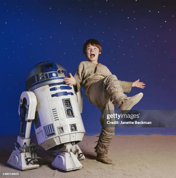 American child actor Jake Lloyd clowns about with R2D2, his robot co-star from 'Star Wars Episode I: The Phantom Menace,' Los Angeles, California,...