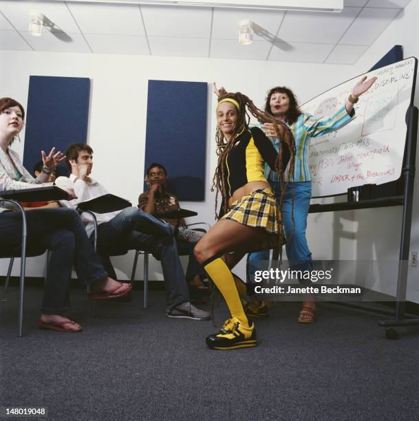 German born author, musician, and academic New York University professor Vivien Goldman and musician Ari Up pose before several people who sit at...