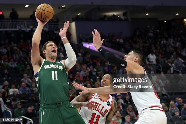 Brook Lopez of the Milwaukee Bucks shoots over Nikola Vucevic of the Chicago Bulls during the second half of a game at Fiserv Forum on April 05, 2023...