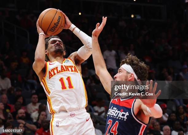 Trae Young of the Atlanta Hawks draws a foul by Corey Kispert of the Washington Wizards during the second quarter at State Farm Arena on April 05,...