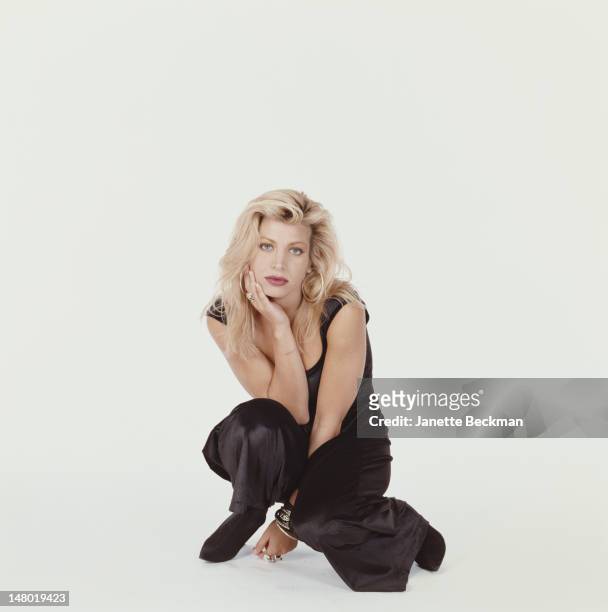 Portrait of American pop singer Taylor Dayne as she poses against a white background, New York, New York, 1989.
