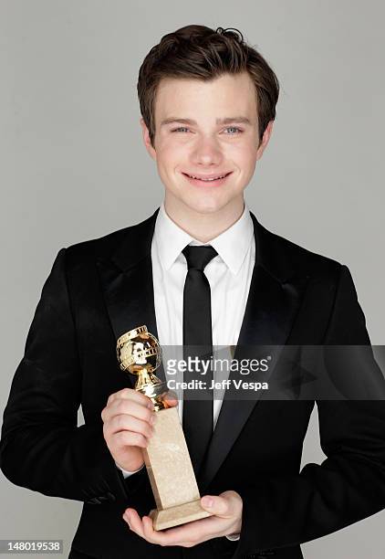 Actor Chris Colfer poses with his award for Best Performance by an Actor in a Supporting Role in a Series, Mini-Series or Motion Picture Made for...