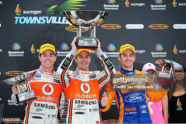 Jamie Whincup Craig Lowndes and Will Davison celebrate on the podium after winning race 15 of the V8 Supercar Championship Series at Reid Park on...