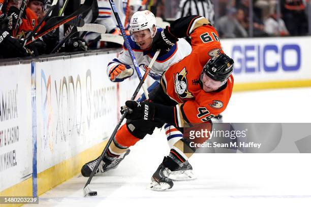 Max Jones of the Anaheim Ducks steals the puck from Nick Bjugstad of the Edmonton Oilers during the first period of a game at Honda Center on April...
