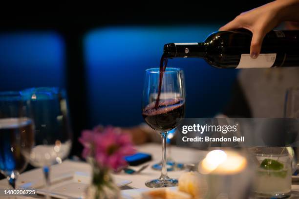 Waitress pours a glass of wine for guests at the It's Italian Cucina restaurant on April 05, 2023 in Austin, Texas. A new analysis of more than 40...