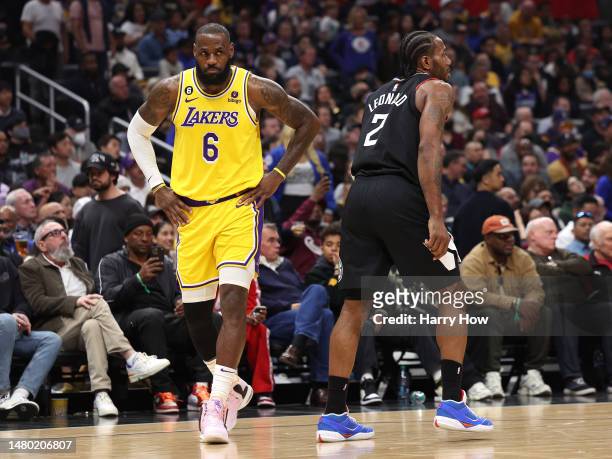 LeBron James of the Los Angeles Lakers reacts behind Kawhi Leonard of the LA Clippers with the Lakers trailing during the first half at Crypto.com...