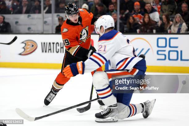Troy Terry of the Anaheim Ducks shoots the puck past the defense of Klim Kostin of the Edmonton Oilers during the second period of a game at Honda...