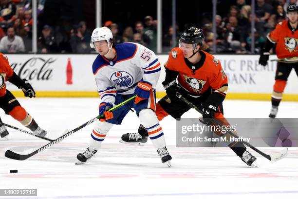 Kailer Yamamoto of the Edmonton Oilers controls the puck past Trevor Zegras of the Anaheim Ducks during the second period of a game at Honda Center...