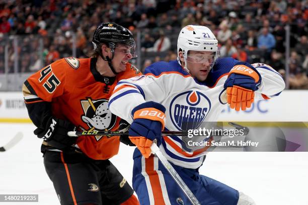 Colton White of the Anaheim Ducks hooks Klim Kostin of the Edmonton Oilers during the third period of a game at Honda Center on April 05, 2023 in...