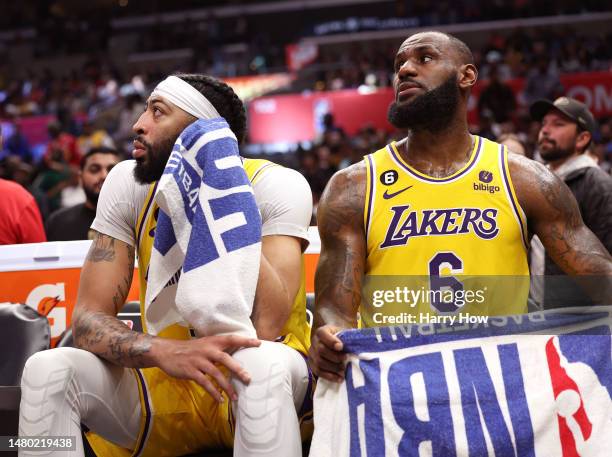 Anthony Davis and LeBron James of the Los Angeles Lakers react from the bench during a 125-118 LA Clippers win at Crypto.com Arena on April 05, 2023...