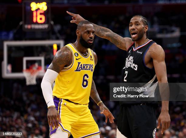 Kawhi Leonard of the LA Clippers directs a play in front of LeBron James of the Los Angeles Lakers during a 125-118 Clippers win at Crypto.com Arena...