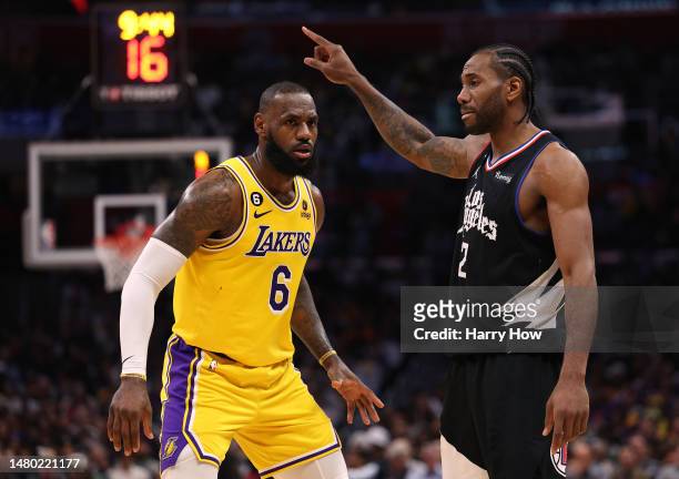 Kawhi Leonard of the LA Clippers directs a play in front of LeBron James of the Los Angeles Lakers during a 125-118 Clippers win at Crypto.com Arena...