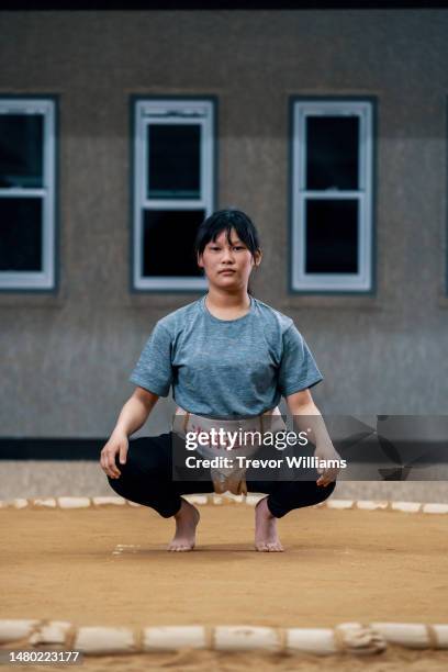 portrait of a young elementary-aged female sumo wrestler - girl wrestling stock pictures, royalty-free photos & images
