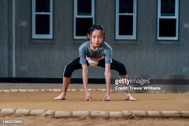 portrait of a young elementary-aged female sumo wrestler - girl wrestling fotografías e imágenes de stock