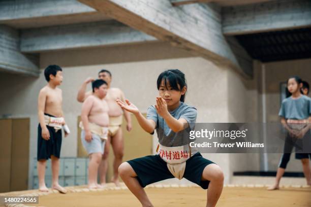 Young elementary-aged girl concentrating at a sumo practice