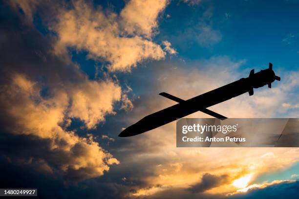 cruise missile against the sunset sky - missile strike stock pictures, royalty-free photos & images