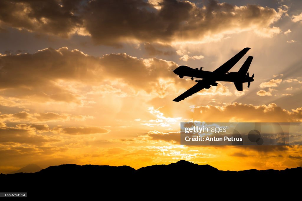 Military unmanned aerial vehicle at sunset. Combat drone in military conflicts