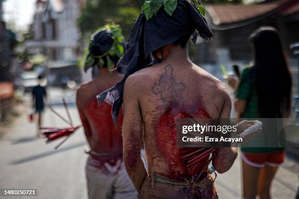 Flagellants whip their bloodied backs as a form of penance as believers observe Maundy Thursday on April 06, 2023 in San Fernando, Pampanga,...