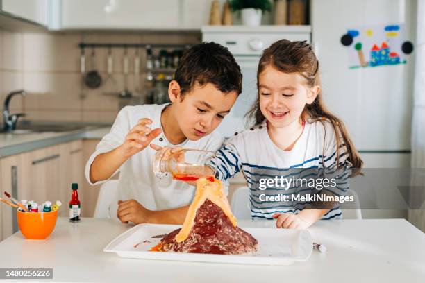 children making experiment at home - volcano experiment stock pictures, royalty-free photos & images