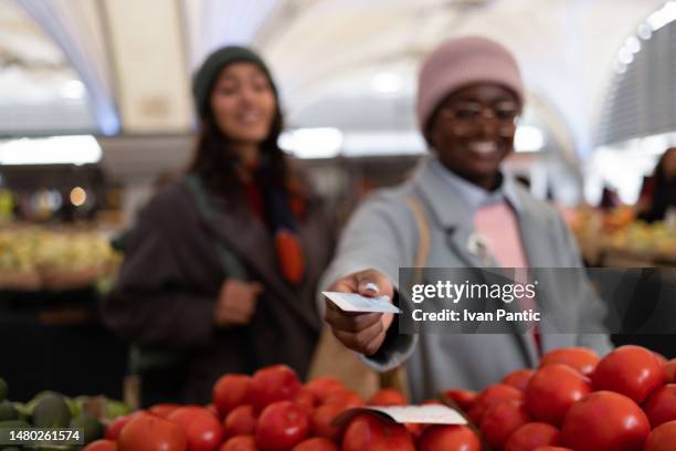 i will pay for the groceries with my credit card! - handing over credit card stock pictures, royalty-free photos & images