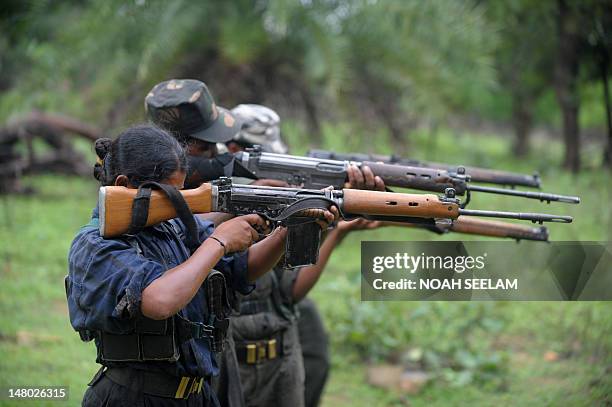 Indian Maoists ready their weapons as they take part in a training camp in a forested area of Bijapur District in the central Indian state of...