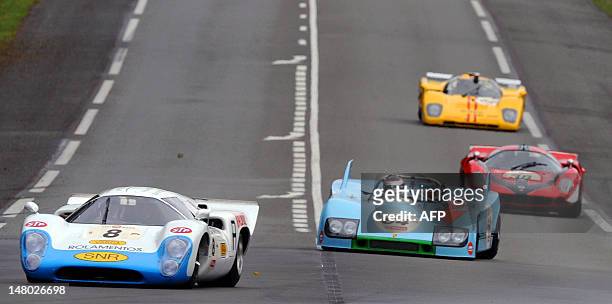 The Lola T70 MK III B driven by Greek Leo Voyazides competes in the lead of the race ahead of the Porsche 908 driven by German Roald Goethe during...