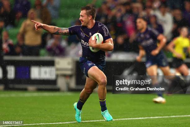 Cameron Munster of the Storm makes a break to score a try during the round six NRL match between the Melbourne Storm and Sydney Roosters at AAMI Park...